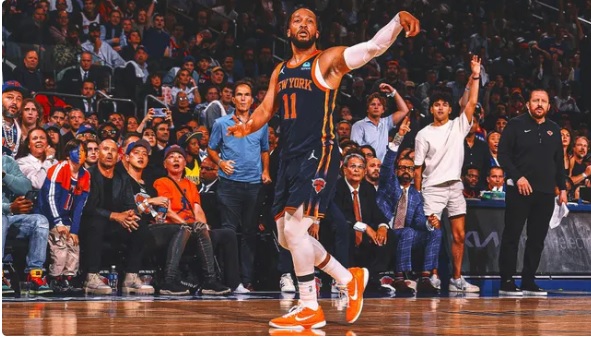 a basketball player in front of a crowd